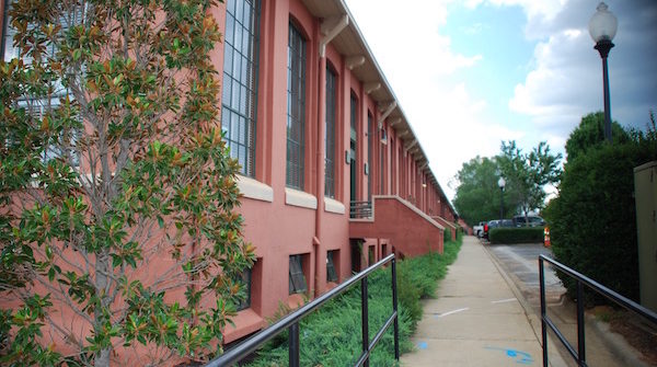 Walkway alongside red brick building with railing