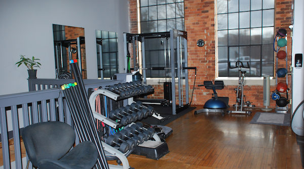 Loft-style gym interior with free weights