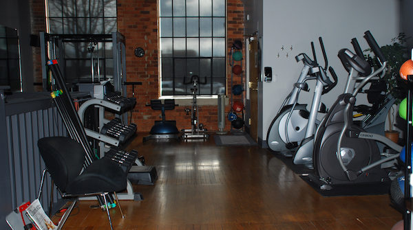 Empty gym with ellipticals and weight machines