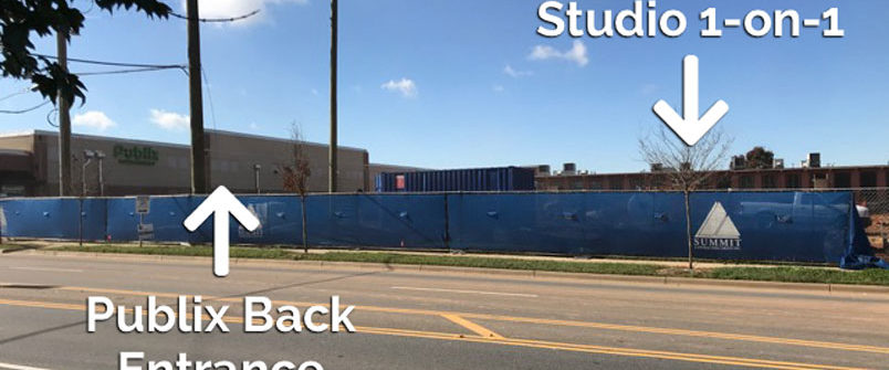 Roadside blue construction fence with directional labels