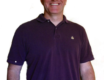 Smiling man wearing purple polo shirt
