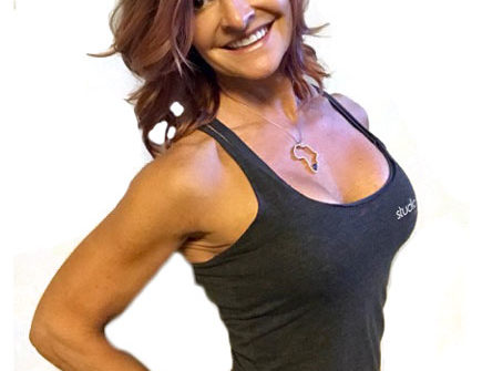 Smiling athletic woman in black tank top