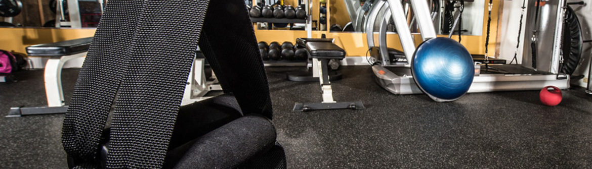 Gym floor with blue exercise ball and kettlebell