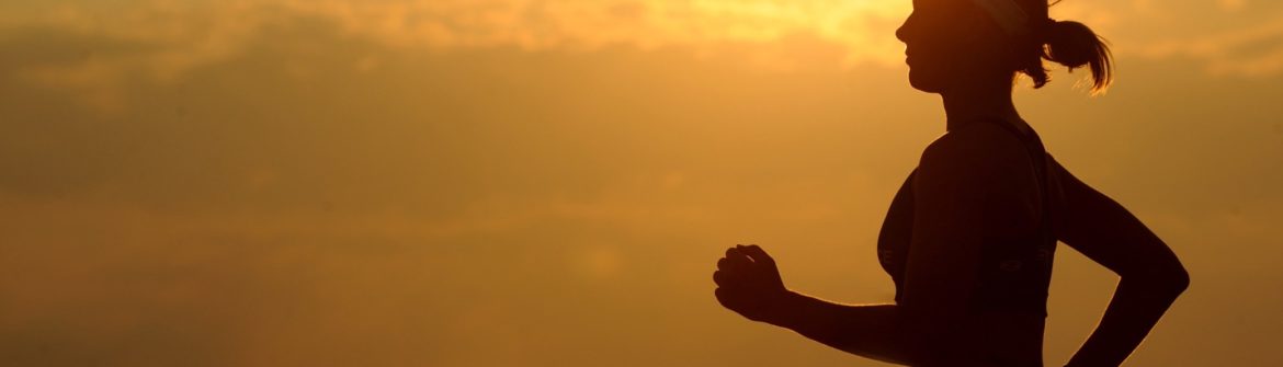 Silhouette of person running at sunset