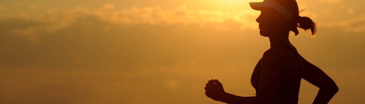 Female runner silhouette at sunset