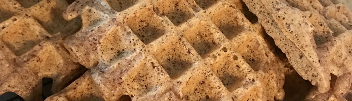 Stack of freshly baked waffles on cooling rack