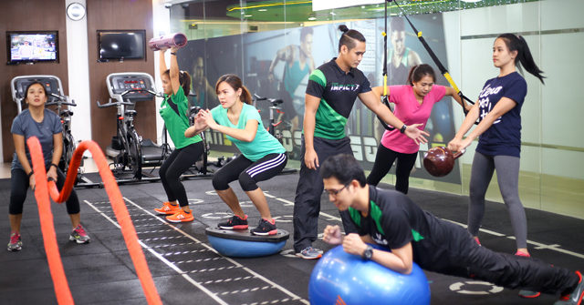 Group fitness class with varied workout equipment