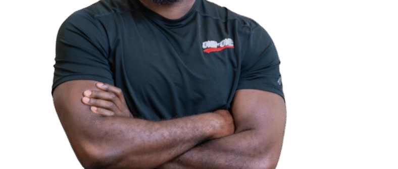 Smiling bearded person with arms crossed