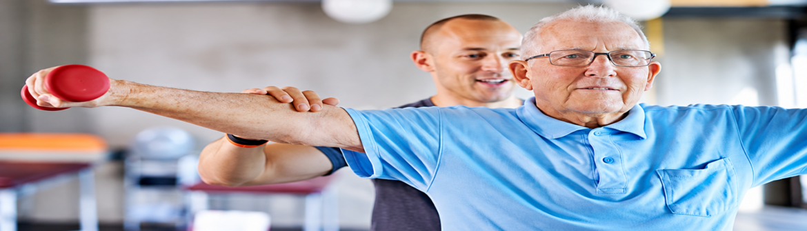 Senior man exercising with personal trainer